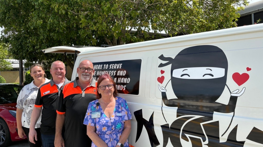 Group of people situated next to a picture of the Night Ninjas van