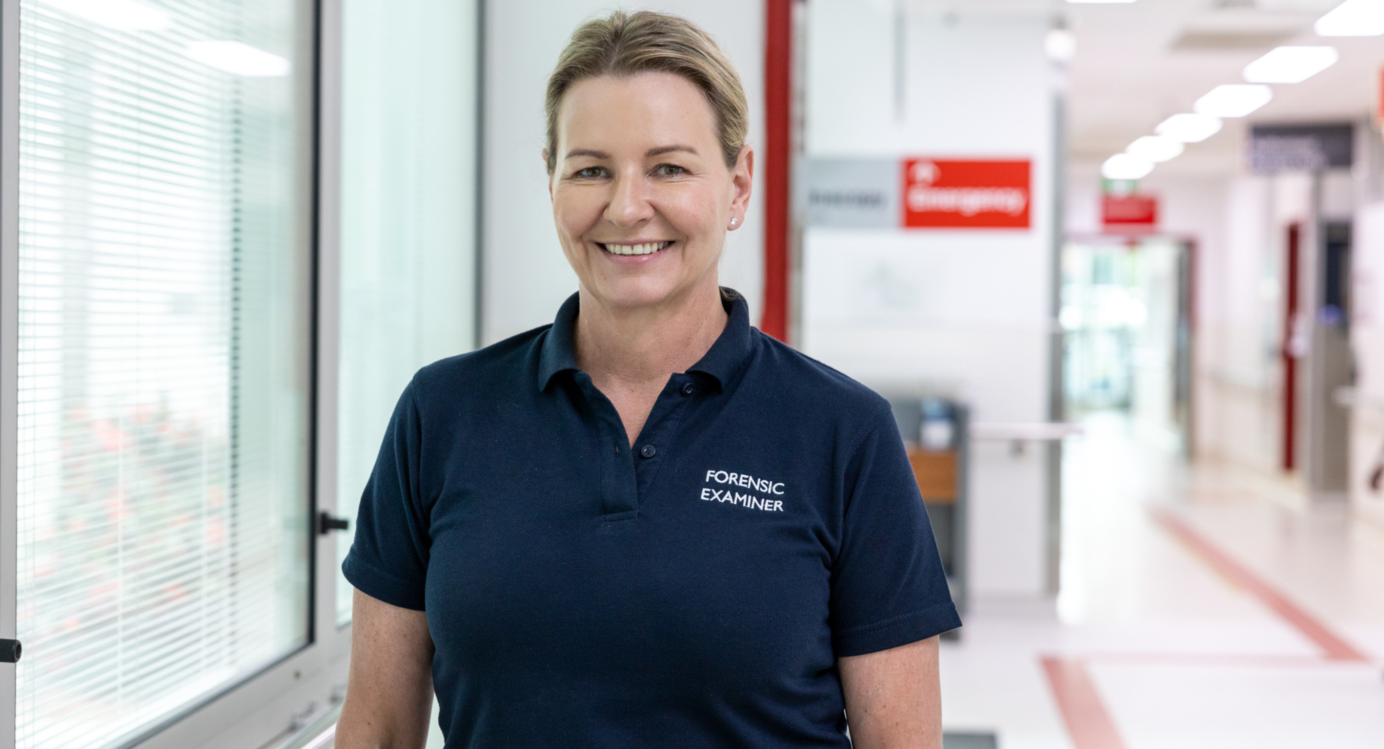 Forensic Nurse standing in hallway smiling