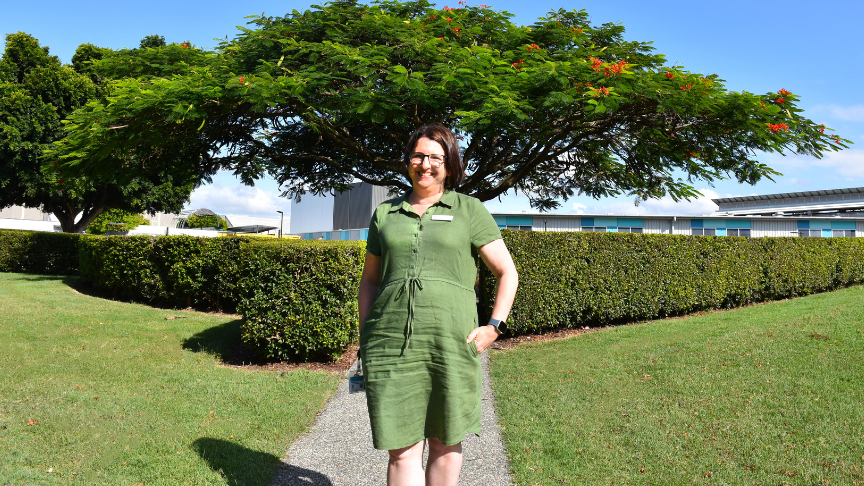 Amanda standing on a pathway in a green field