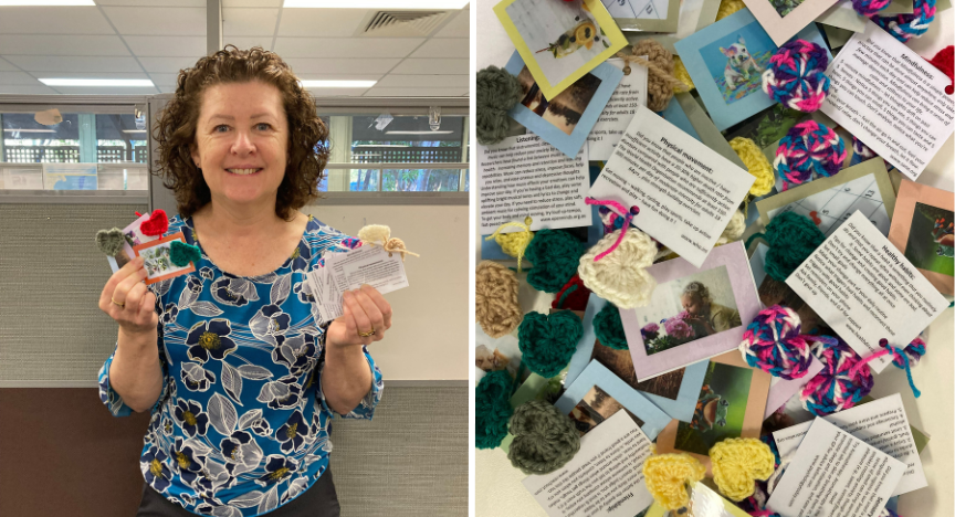 A person holding handmade heart-shaped crafts and cards. Close-up of more crafts and cards with messages and photos on a table.