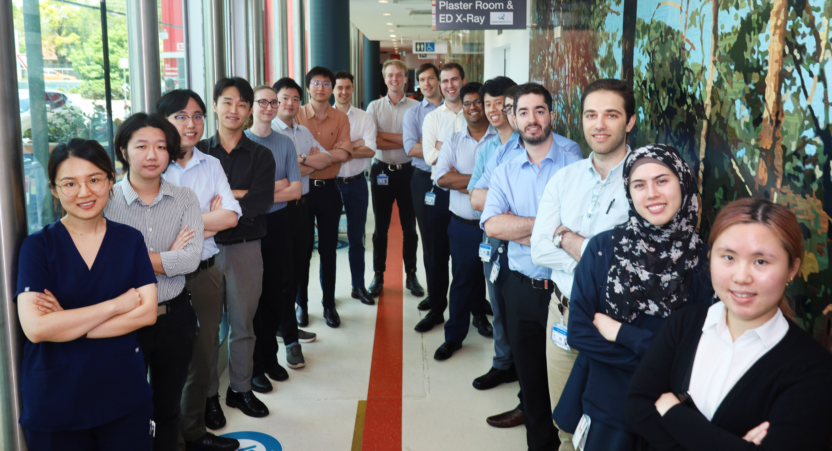 18 medical interns lined up in hallway at QEII Hospital