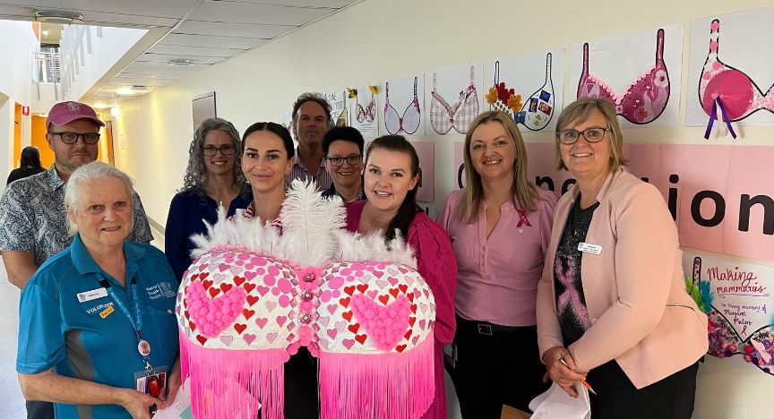 Judges holding giant decorated bra