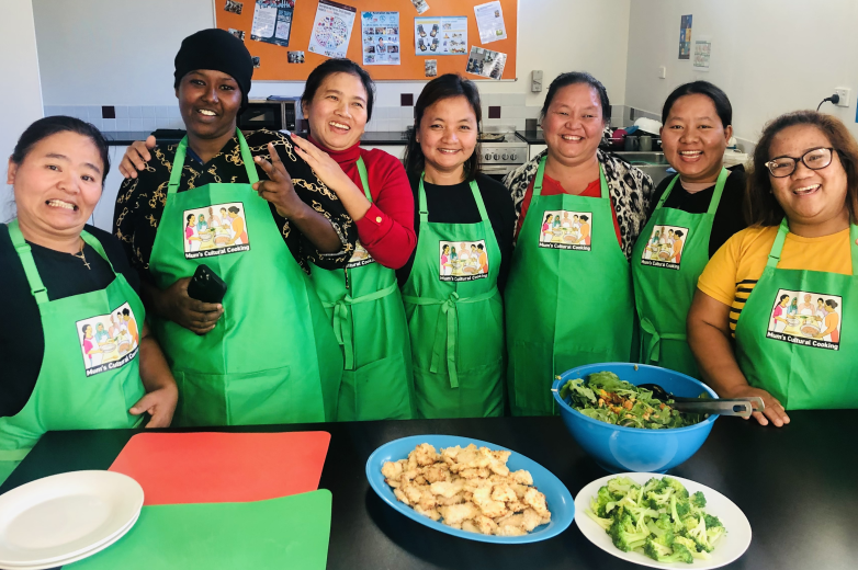 A multicultural group of people cooking healthy food